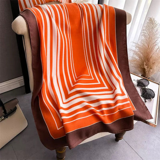 Orange white brown geometric stripe stole draped on armchair - bold chevron viscose cotton scarf