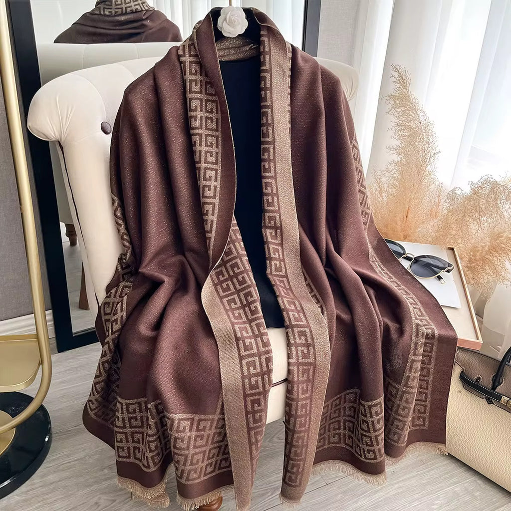 Brown patterned scarf draped over a chair in a room with decor elements.