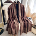 Brown patterned scarf draped over a chair in a room with decor elements.