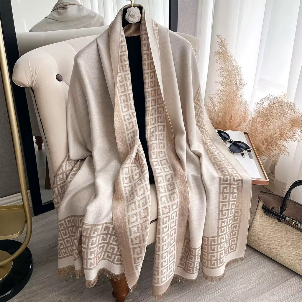 Beige patterned scarf draped over a chair with a neutral background