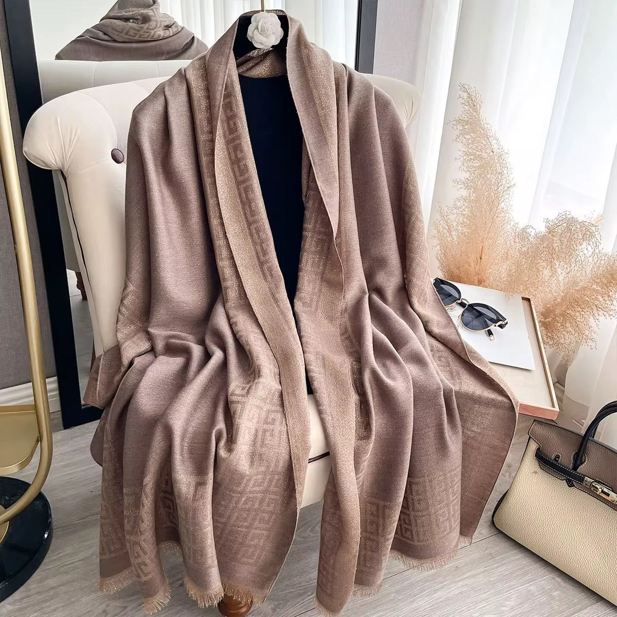 Beige scarf draped over a chair in a room with decor elements.