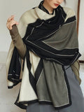 Person wearing a black, white, and gray patterned scarf