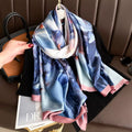 Colorful scarf with floral pattern draped over a handbag on a brown surface