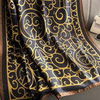 Black fabric with gold intricate pattern draped over a surface