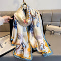Colorful scarf with floral design held by a hand on a couch background