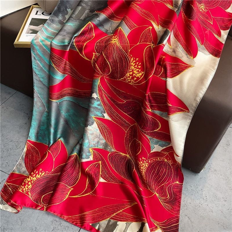 Close-up of the Boxy Luscious Silk Scarf highlighting the bold red floral print, delicate gold linework and the rich teal, taupe and ivory abstract background with a silky sheen.