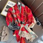 Boxy Luscious Silk Scarf displayed in a luxurious flat lay arrangement, showcasing vibrant red floral blooms with intricate gold accents on a teal, grey and ivory marbled base.