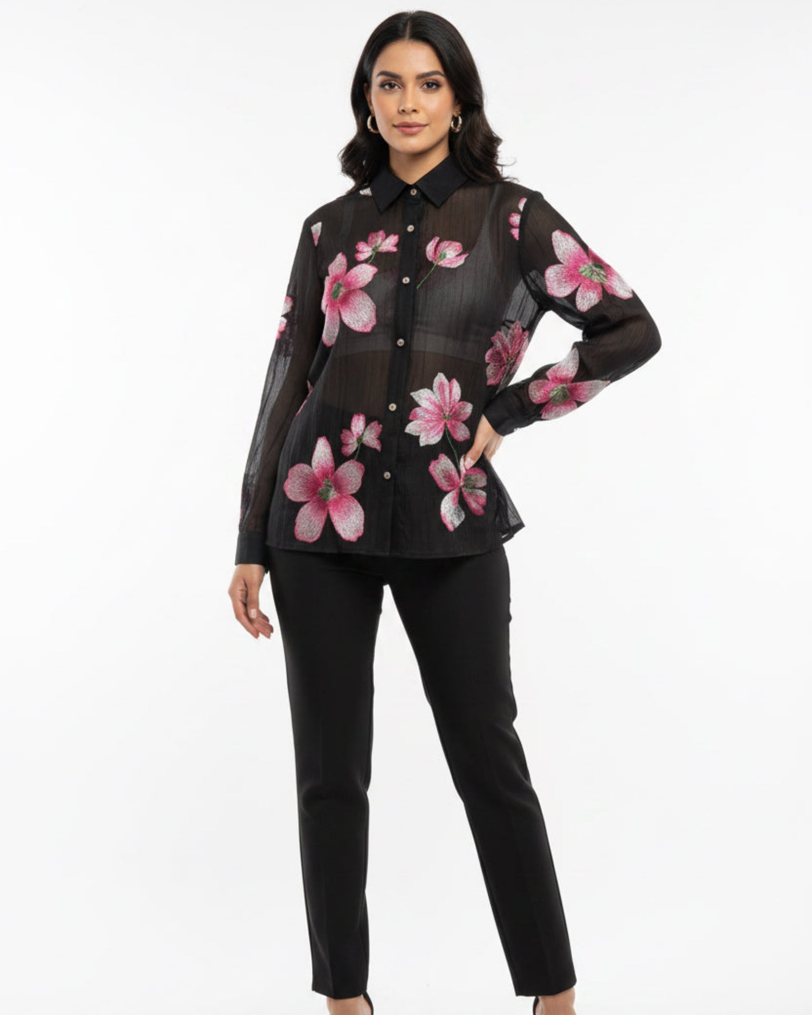 Black shirt with pink floral patterns on a wooden surface