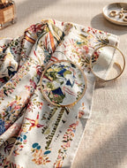 Decorative table setting with floral-patterned cloth and ornate plates.