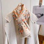 Floral patterned scarf draped over a white coat with a neutral background
