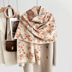 Floral patterned scarf draped over a coat with a handbag in the background.
