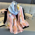 Floral patterned scarf draped over a couch with a handbag in the background