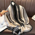 Black and white patterned scarf held by a hand on a brown surface