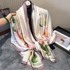 Floral patterned scarf held by a hand on a neutral background