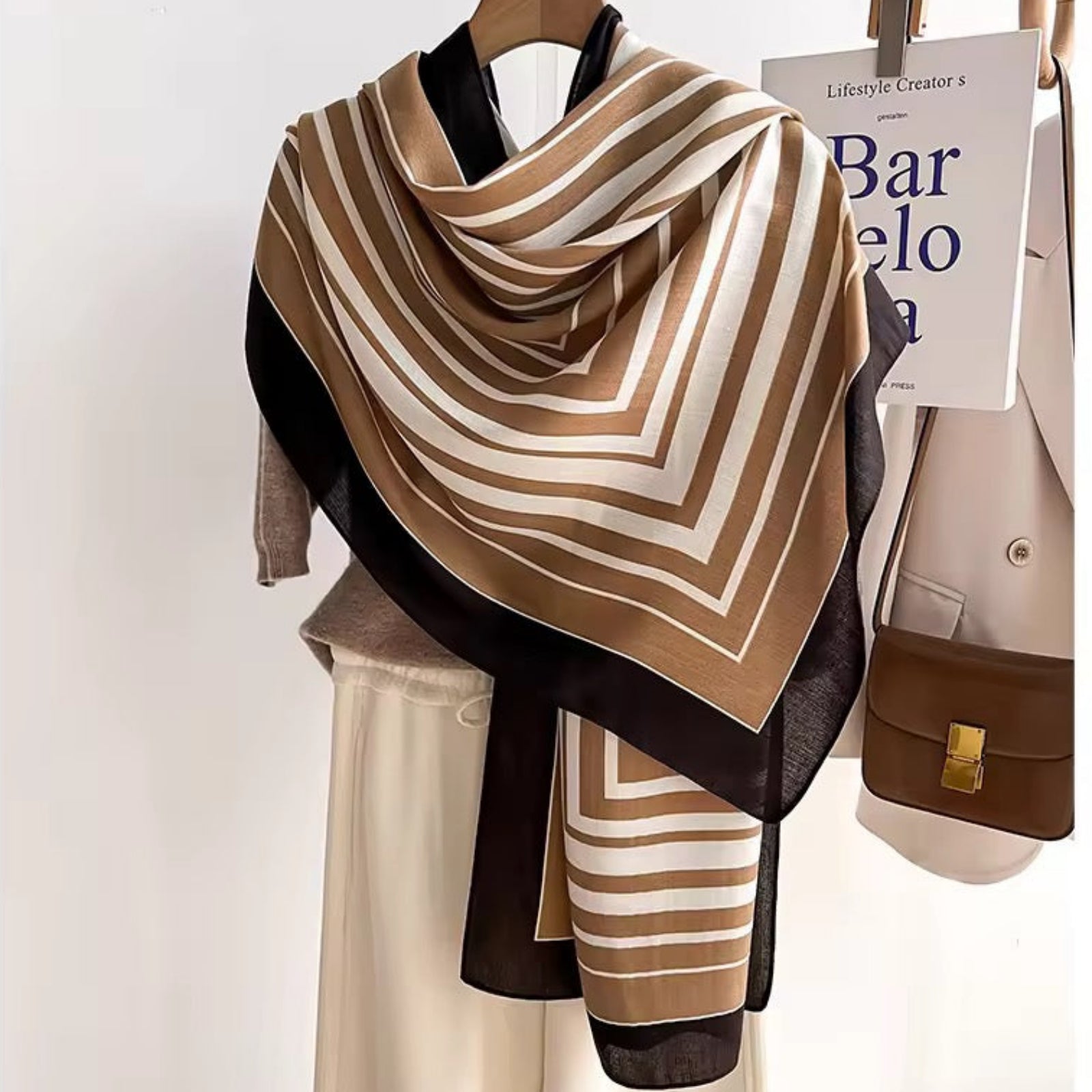 Hais Chevron Striped Viscose Cotton Stole styled as shoulder wrap in camel, ivory and black