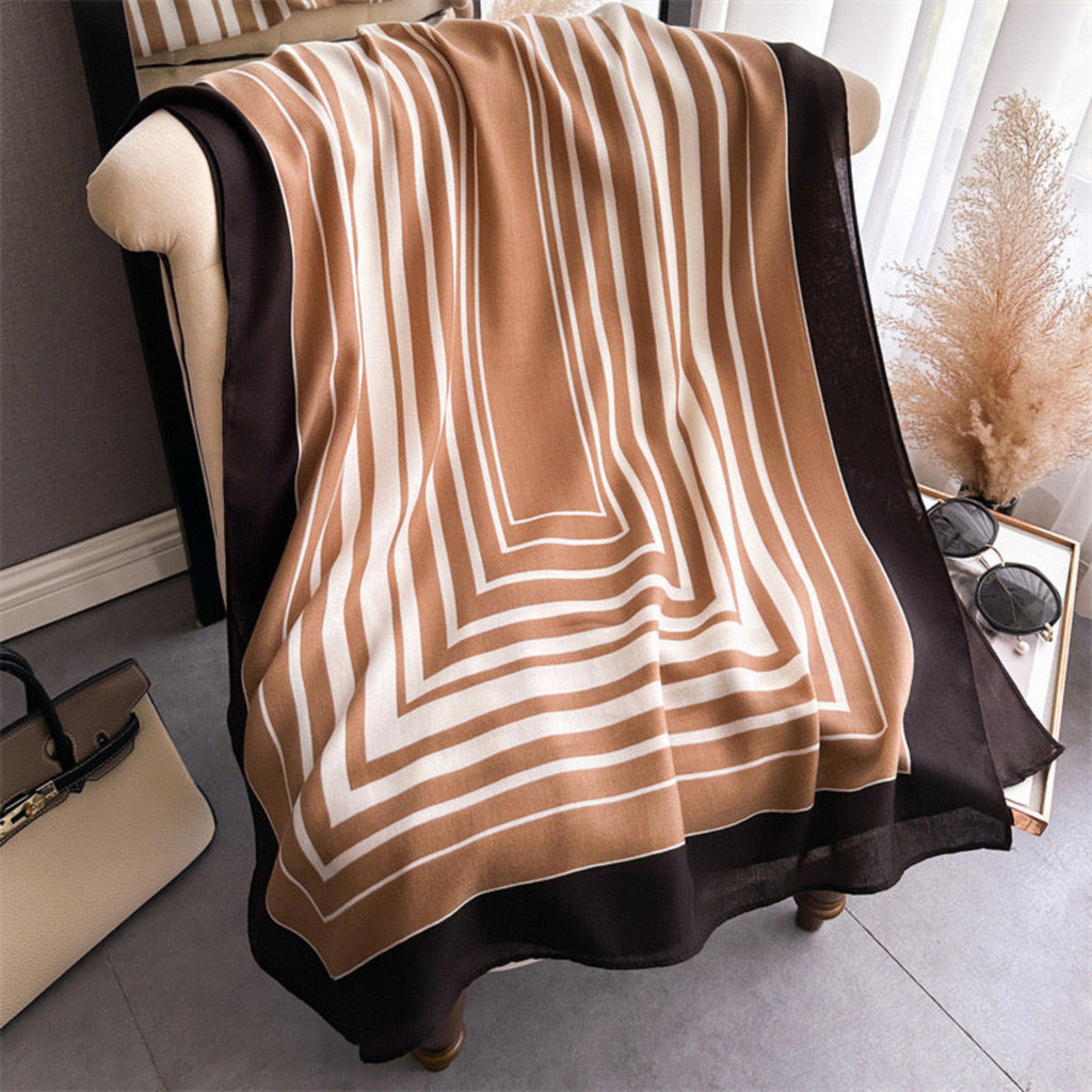 Hais striped viscose cotton stole draped around neck over white sweater in camel and black