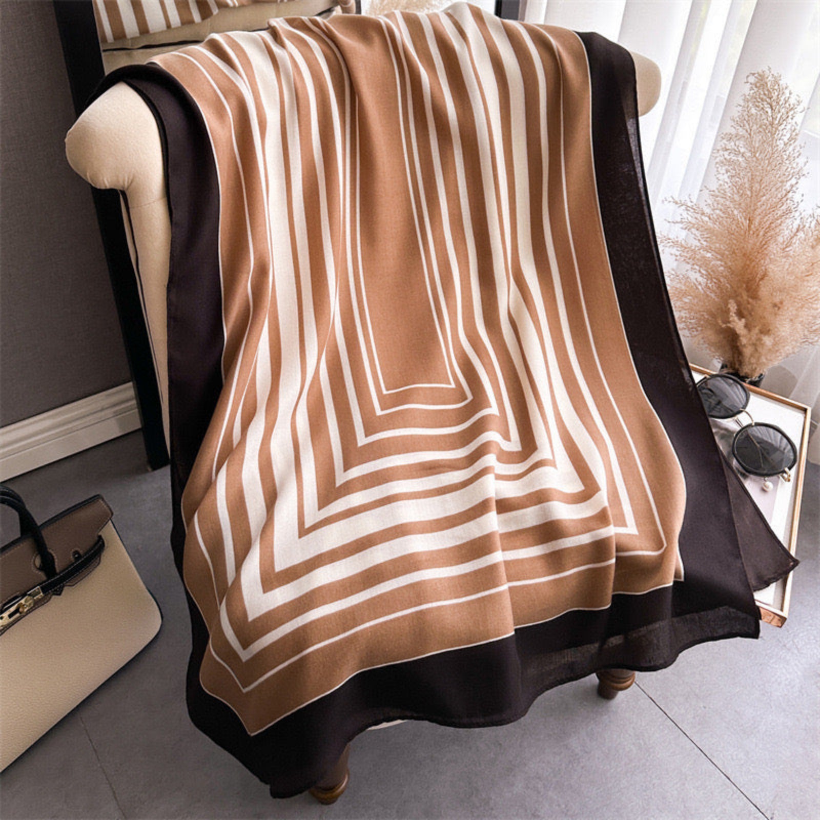 Hais striped viscose cotton stole draped around neck over white sweater in camel and black