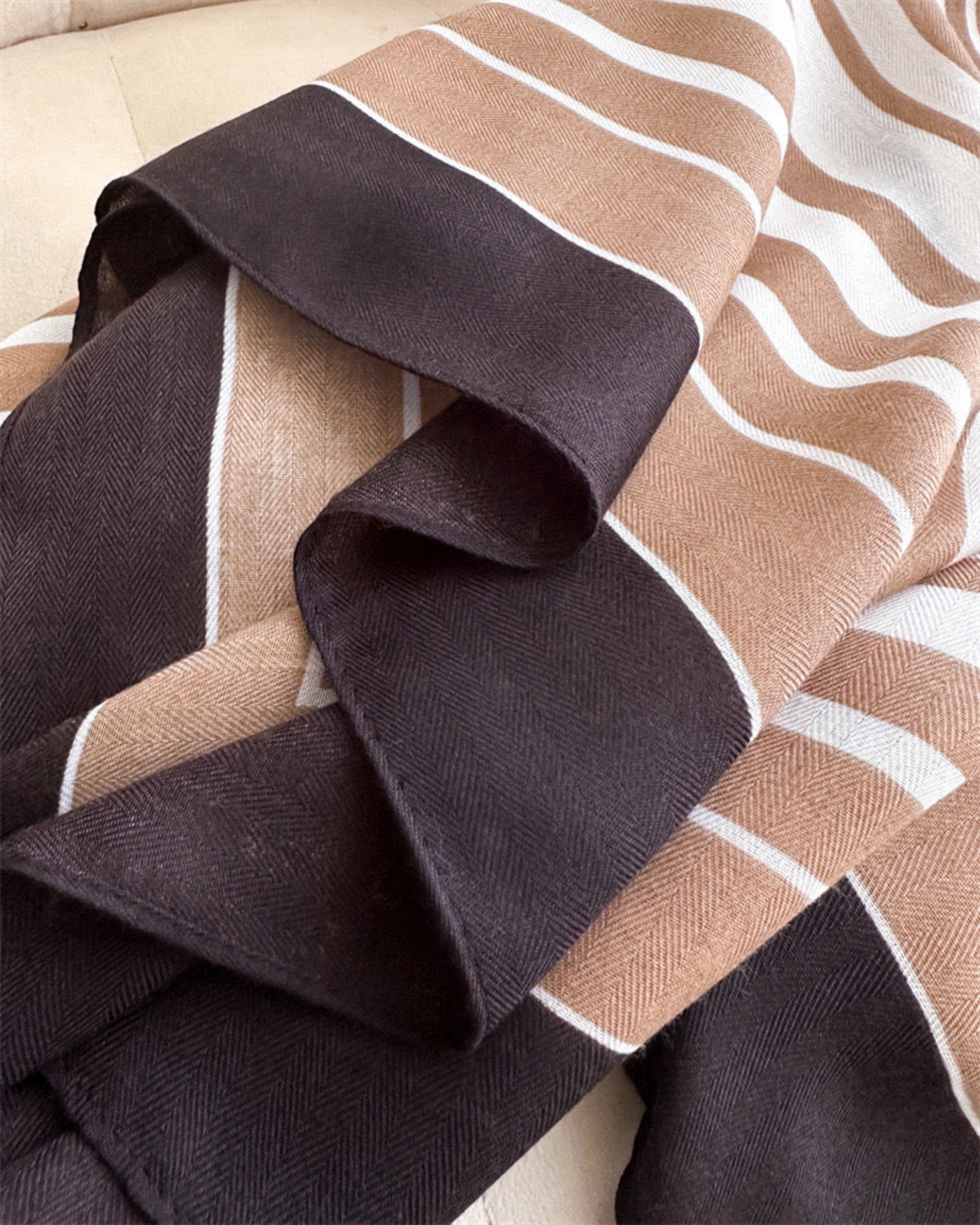 Detail shot of Hais striped stole showing deep espresso black border and camel stripe herringbone finish