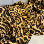 Leopard print fabric with a soft texture on a white background