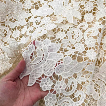Close-up of cream guipure lace fabric detai