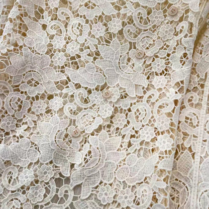 Detail shot of scalloped floral lace top button closure