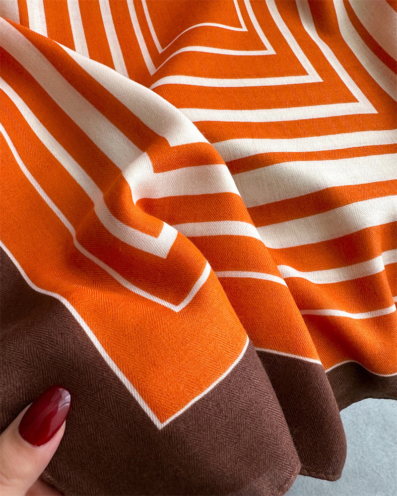 Close-up of orange white geometric stripe viscose cotton stole showing chevron pattern and brown border