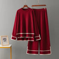 Red outfit with white trim on hangers against a gray background