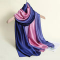 Multicolored scarf draped over a hanger on a light background
