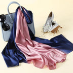 Navy and pink satin scarf with a handbag, sunglasses, and high-heeled shoes on a light yellow background