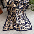 Navy printed silk stole styled on chair