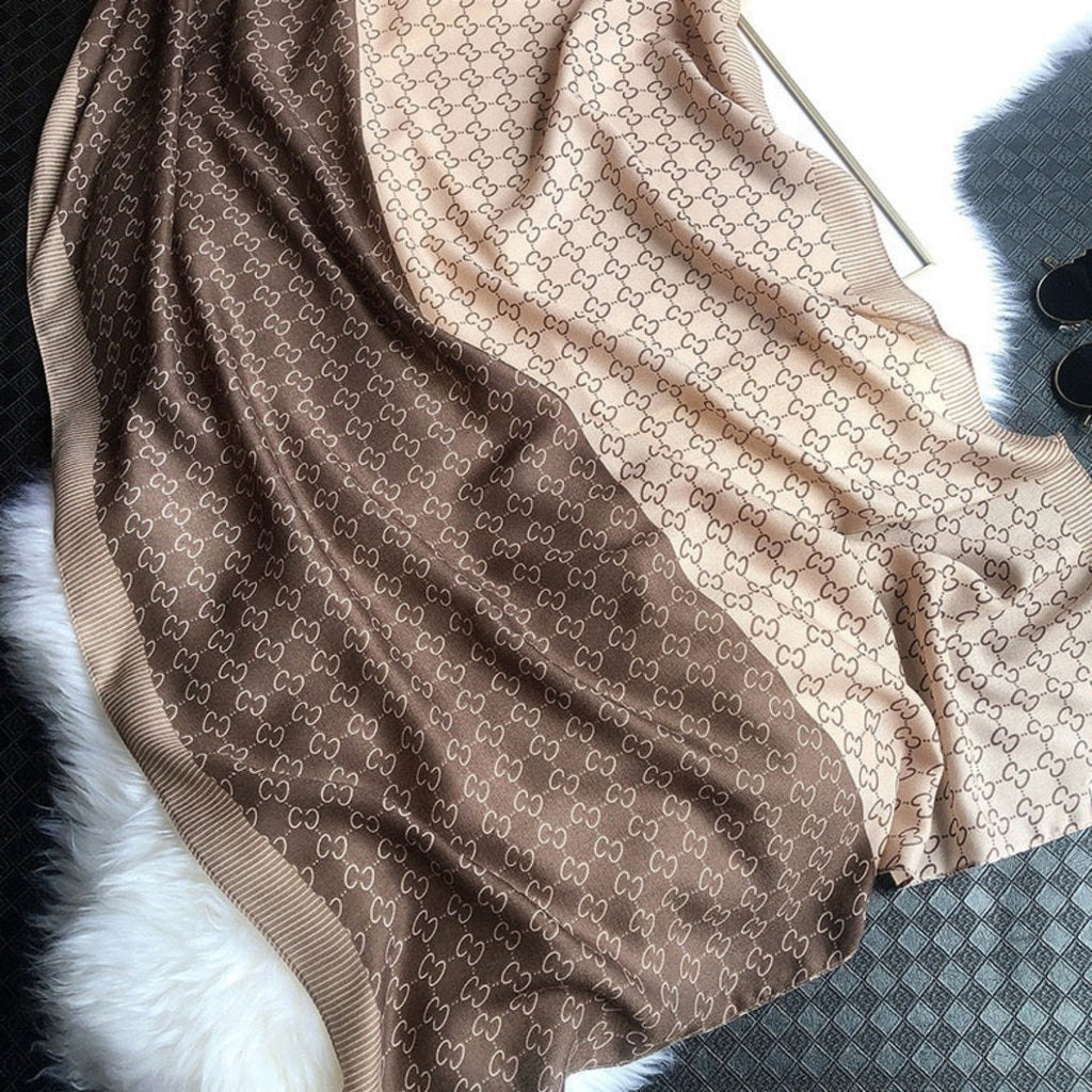 Brown and beige patterned fabric on a textured surface