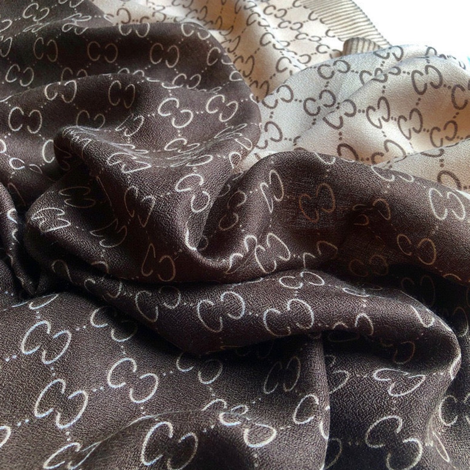 Dark brown fabric with a subtle pattern on a plain background