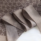 Brown textured fabric with a subtle pattern on a white background