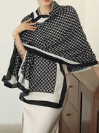 Person wearing a black and white patterned scarf