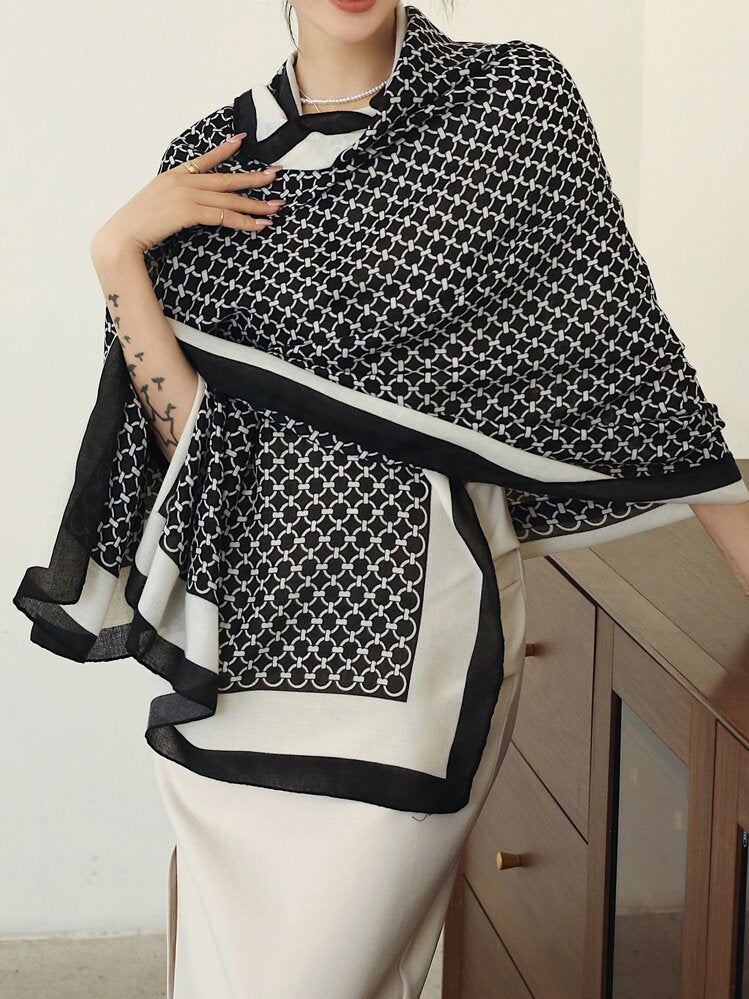 Person wearing a black and white patterned scarf