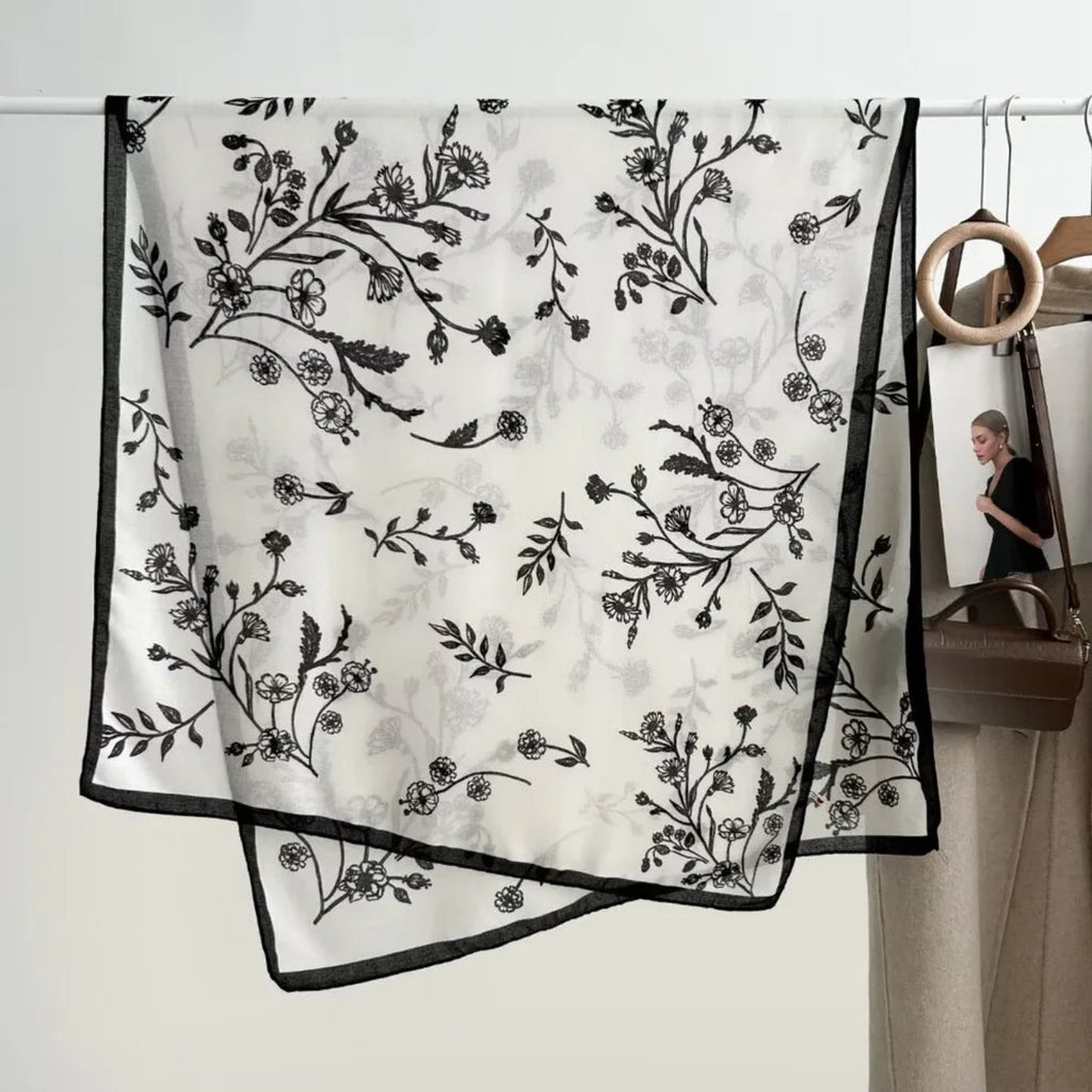 Black floral patterned scarf on a white background