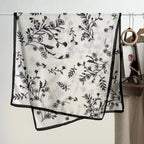 Black floral patterned scarf on a white background