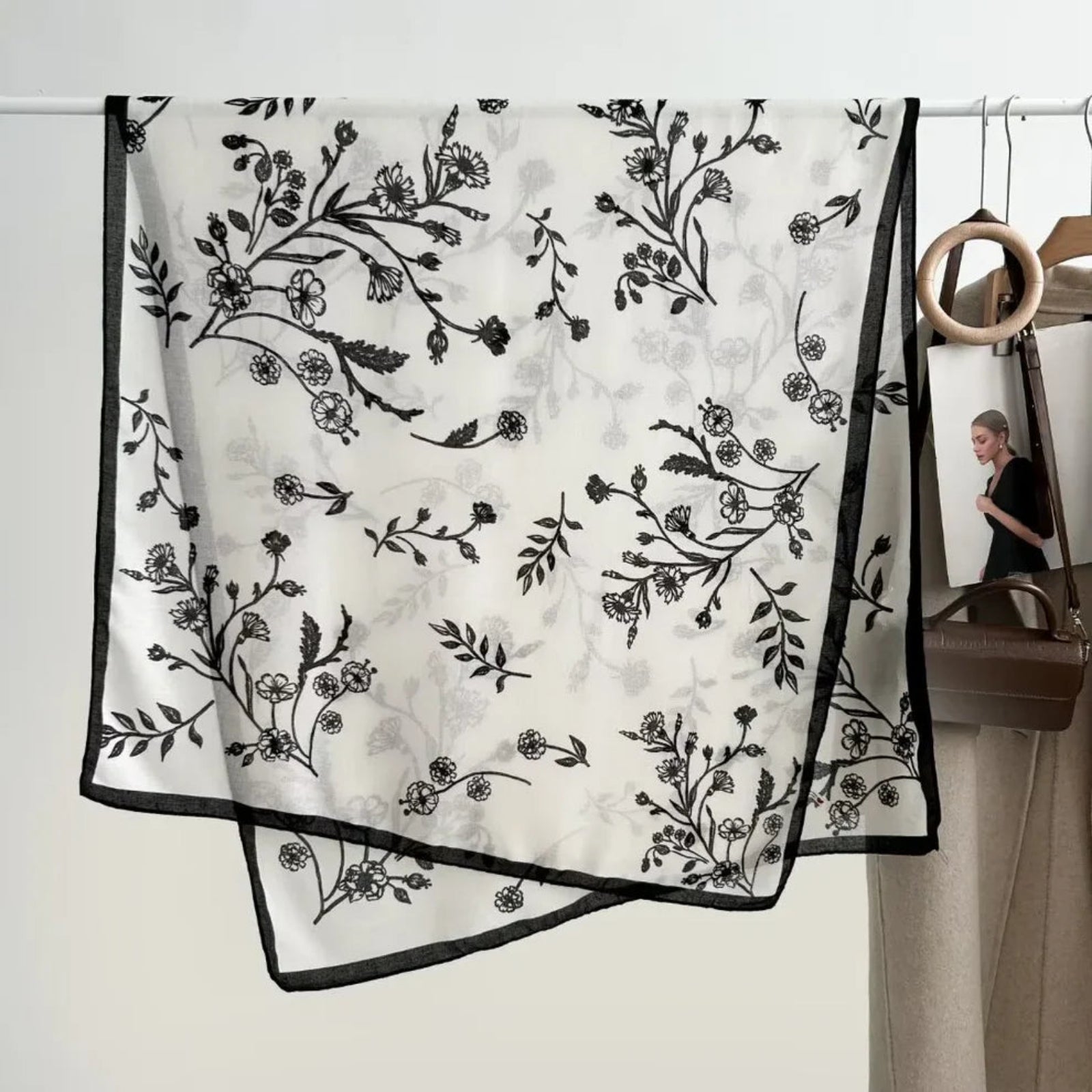 Black floral patterned scarf on a white background