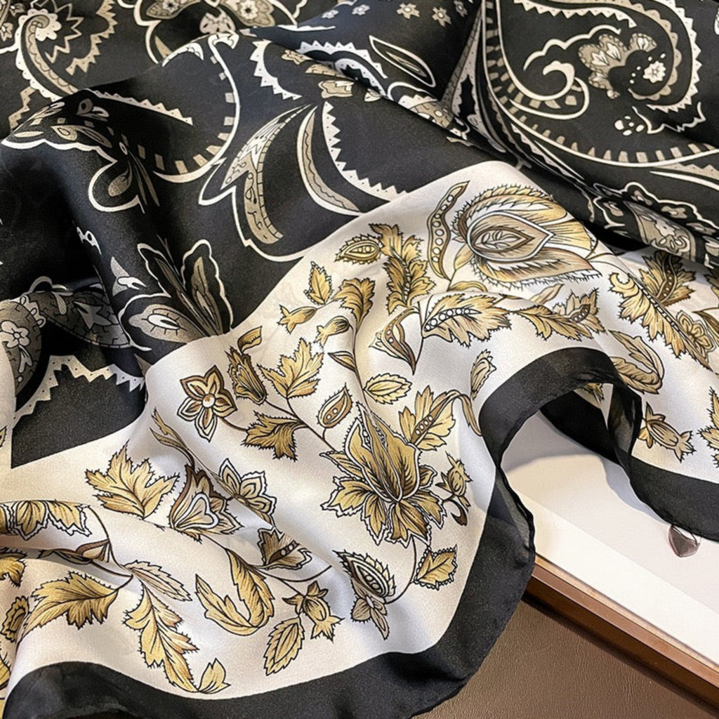 Black and gold paisley patterned fabric on a white background
