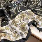 Black and gold paisley patterned fabric on a white background