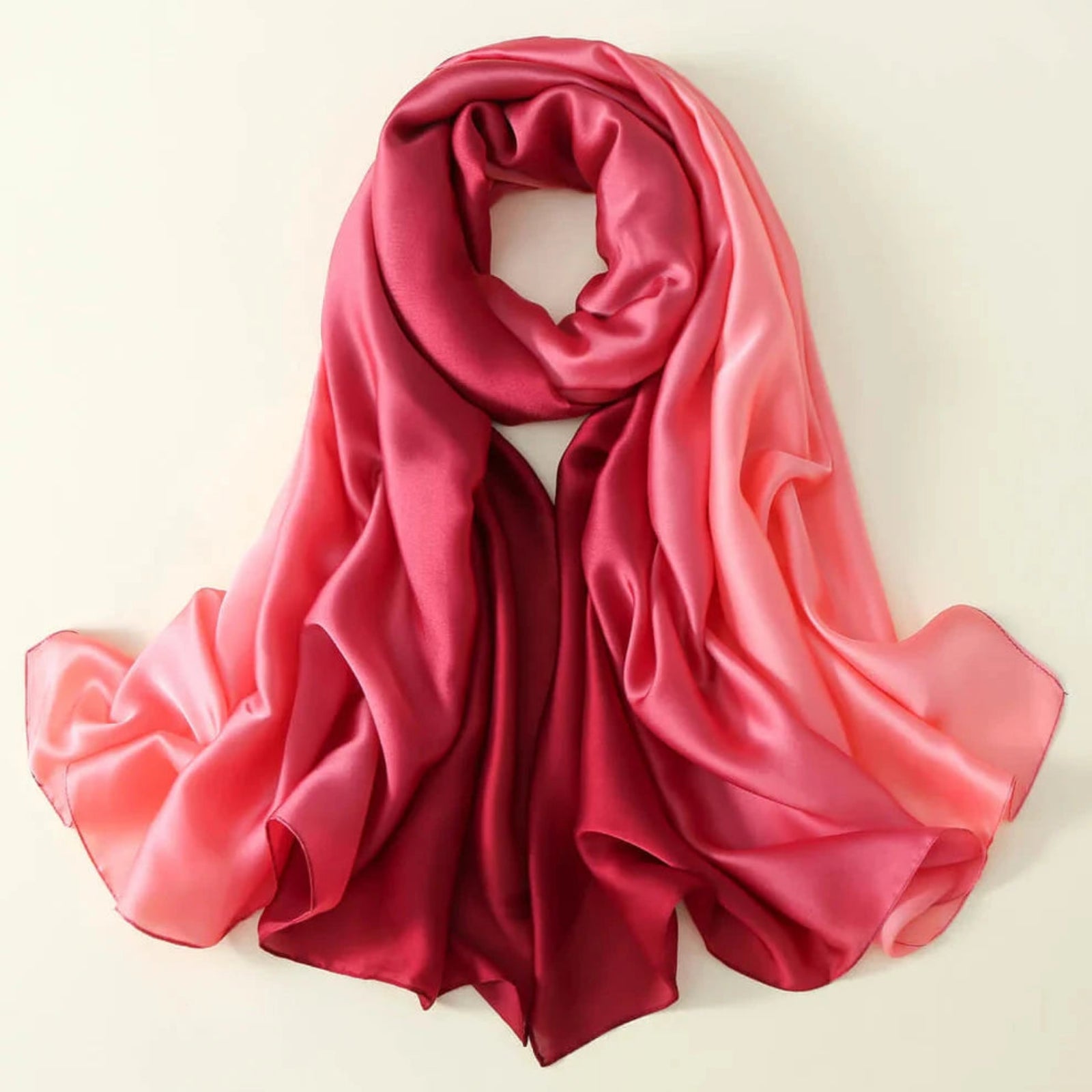 Pink and red gradient scarf on a light beige background