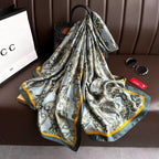 Patterned scarf on a brown surface with a Gucci bag in the background