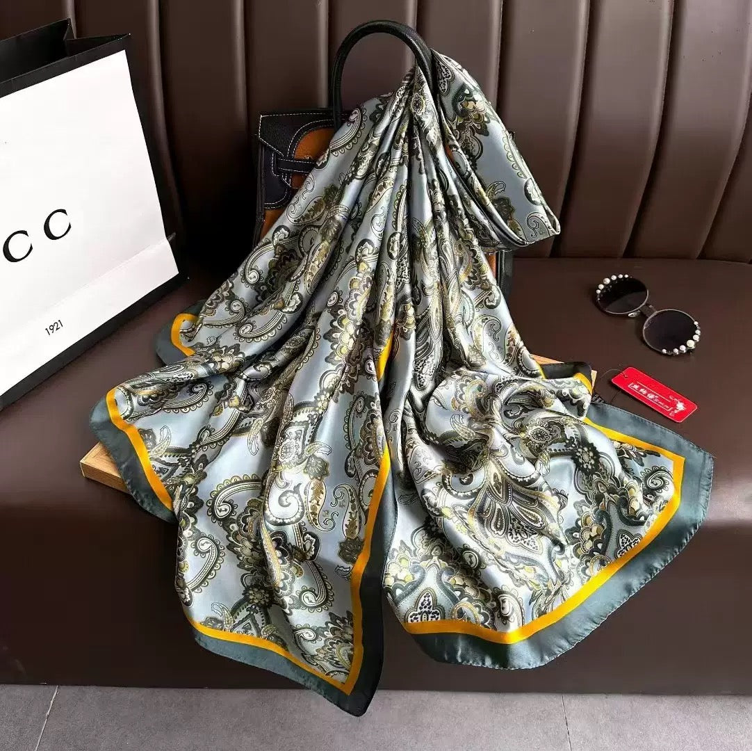 Patterned scarf on a brown surface with a Gucci bag in the background