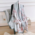 Floral scarf draped over a chair in a room with a neutral background