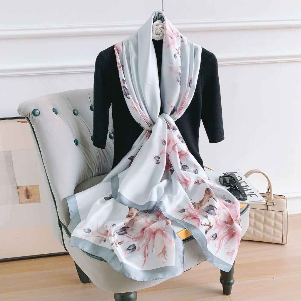 Floral scarf draped over a chair with a neutral background