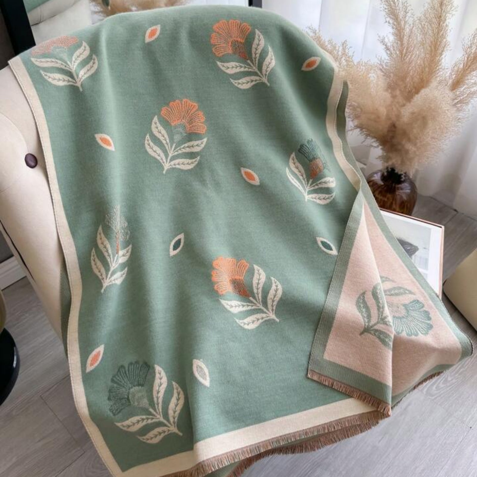 Floral patterned blanket on a surface with decorative elements in the background