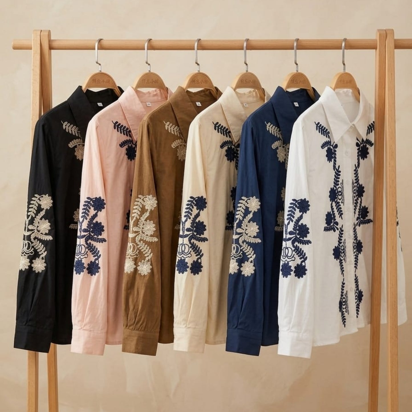 The Jardin Embroidered Cotton Shirt — all 6 colour variants displayed on wooden clothing rack