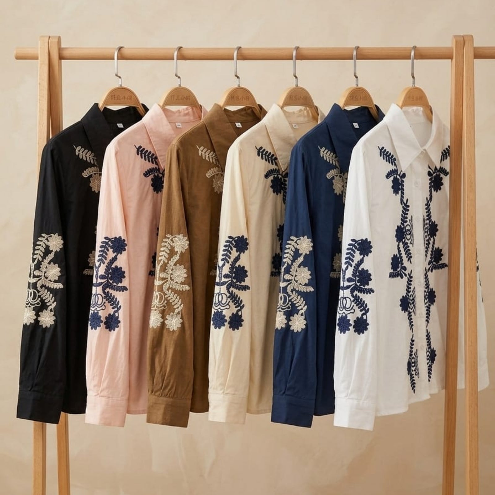 The Jardin Embroidered Cotton Shirt — all 6 colour variants displayed on wooden clothing rack