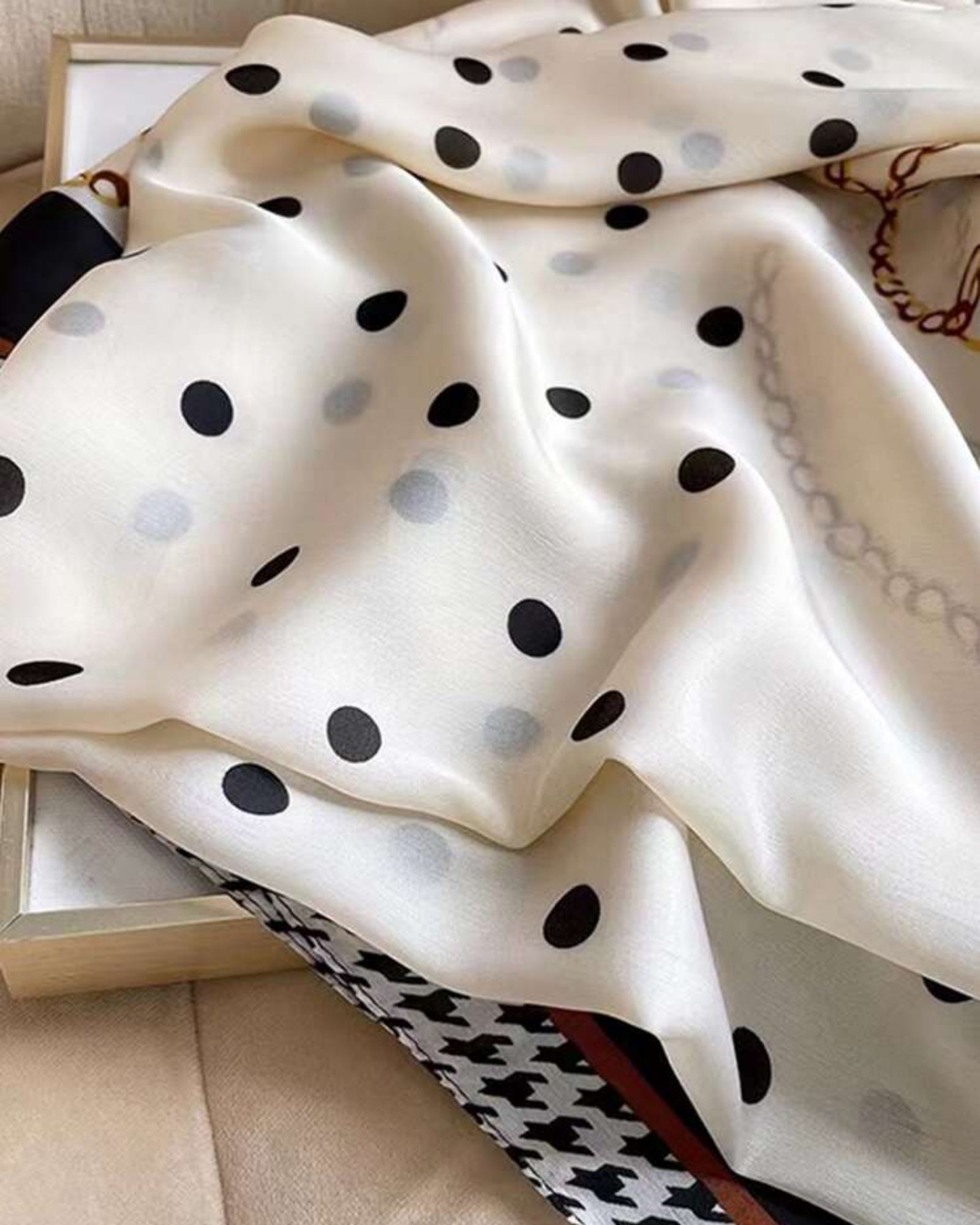 Close-up of Maison Trio Scarf polka dot body and gold chain border detail — imitation silk texture