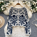 Riviera Fan Cardigan styled with denim shorts — front button closure detail
